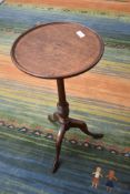 A 19TH Century oak wine table, having turned column and triple splay legs, diameter approx. 30cm