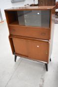 A vintage sapele secretaire bureau with display section and sliding doors to lower section, width