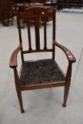 An early 20th Century mahogany carver chair having rail back, roundel decoration to back rail