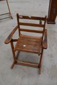 A vintage childs folding rocking chair