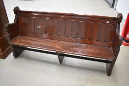 A traidtional stained pine church pew, length approx. 180cm