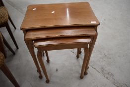 A reproduction nest of three sapele tables