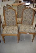 A set of four light oak dining chairs in a light oak by Parker Knoll