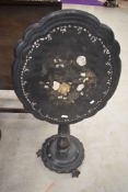 A 19th Century papier mache tilt top table on ebonised pedestal, some mother of pearl detailing , in