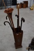 A vintage stick stand and contents, including copper horn