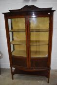 An early 20th Century mahogany display cabinet with lower double cupboard section, lined interior,