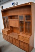 A mid century design wall unit by Nathan having glazed display shelving 190cm long