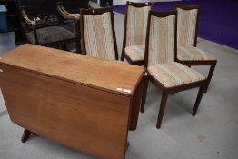 A vintage G plan gateleg dining table and four similar upholstered dining chairs