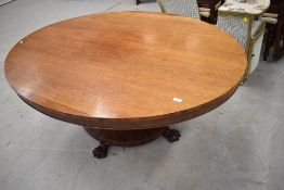 An early 19th century possibly William IV dining table of oval form on tilt top having mahogany
