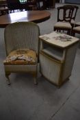 An art deco woven fibre nursing chair and a matching bed side cupboard or stand