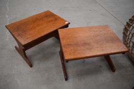 A pair of vintage teak side tables, stylised form, width each approx. 54cm