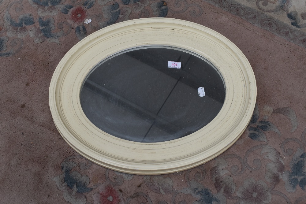 A modern oval wall mirror , approx. 54 x 44cm