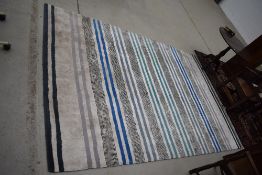 A modern rug, striped pattern, approx. 300 x 200cm, labelled for Designers Guild, nice quality but