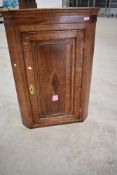 A 19th Century mid colour oak corner cupboard, height approx. 102cm