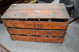 A vintage egg crate, branded for Garstang and a selection of terracotta plant pots