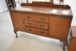 An early 20th Century mahogany sideboard having ledge back and cabriole legs, width approx. 150cm