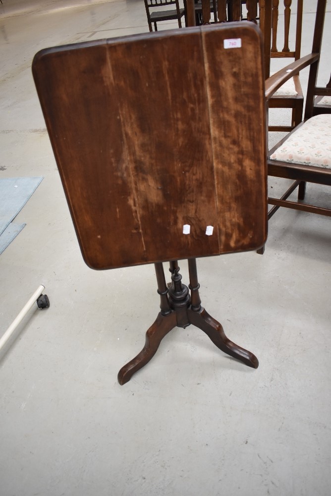 A Victorian mahogany folding occasional table, having triple column support on splay legs, in need