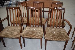 A vintage teak G plan (whale tail design) extending dining table and six (four plus two) chairs