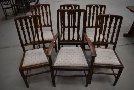 A set of six (five plus one) early 20th Century oak dining chairs, later upholstered seats