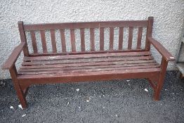 A stained frame garden bench, wood still looks sturdy enough