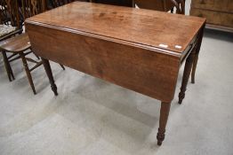 A Victorian mahogany pembroke table having turned frame