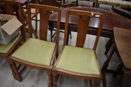 A set of four mid 20th Century oak and ply dining chairs