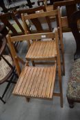 A pair of folding wooden chairs