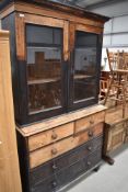 A 19th Century part stripped display cabinet/bookcase on drawer base of two over three drawers,