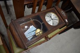 An early 20th Century oak cased wall clock