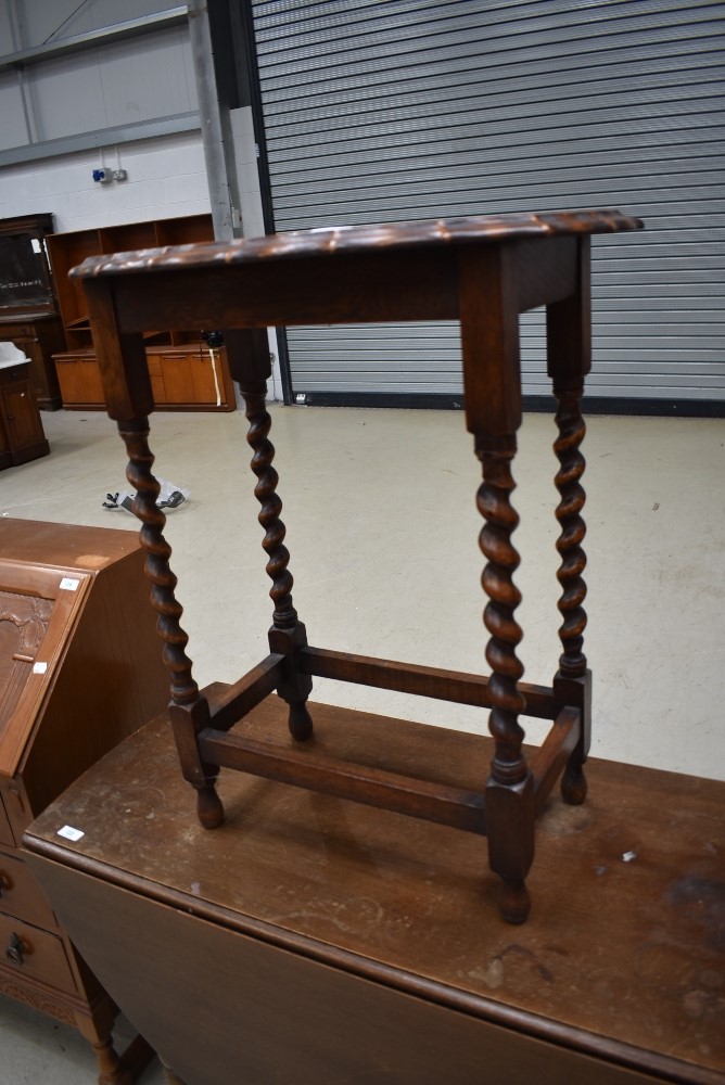 An early 20th Century oak twist frame occasional table