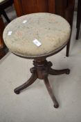 A 19th Century mahogany frame piano stool having overstuffed circular top