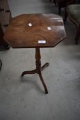 A 19th Century mahogany occasional pedestal table having octagonal top with warped veneer on