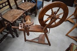 A traditional spinning wheel, possibly yew wood