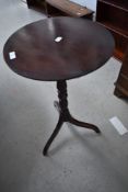 A 19th Century mahogany occasional pedestal table having circular top on turned column and triple