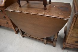 A traditional oak gateleg table having turned frame