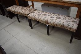 A pair of late 19th or early 20th Century window seats having tapered mahogany legs and later