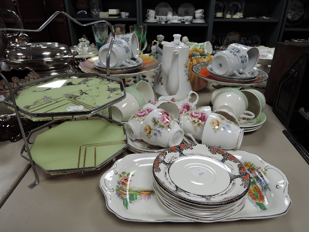 A mixed lot of ceramics including floral cups and saucers, coffee pot, cake stands and more.