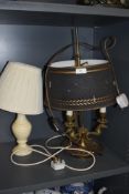 Two table or bed side lamps including three branch ormolu decorated and a turned stone lamp base