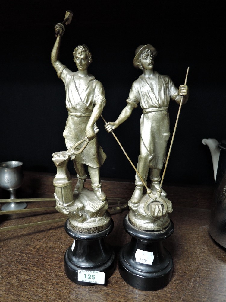 a pair of mantle garniture figures for industry and commerce