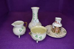 Three pieces of Belleek porcelain and a small vase by Royal Crown Derby