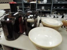 A selection of vintage traditional mixing bowls and two juicers.