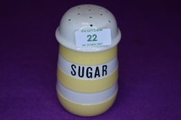 A vintage kitchen Cornish wear sugar sifter in yellow glaze with a green T.G Green back stamp