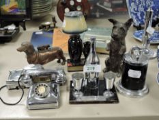 An assortment of vintage lighters including novelty begging terrier and dachshund desk lighter.