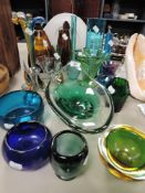 An array of colourful glass vases and bowls.