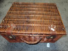 An empty wicker picnic hamper.