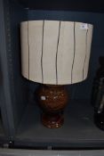 A mid century pottery lamp having genuine vintage shade to match