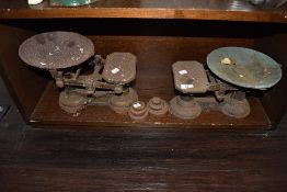 Two sets of vintage kitchen balance scales with some weights