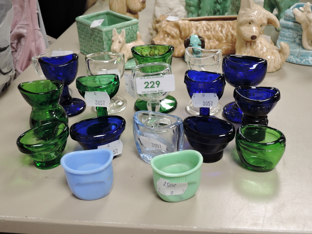 A collection of vintage and antique eye baths,blue and green glass examples, others early plastic.