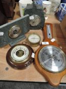 Four vintage barometers including slate mantel examples.