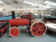 A home made model of a Steam Traction Engine having LMS rear wheels having red body and white roof